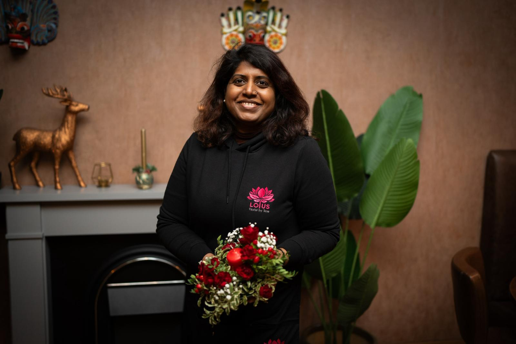 Lotus Florist lead floral designer with bespoke arrangement